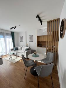 een woonkamer met een bank, een tafel en stoelen bij Safran 604 in Zlatibor +20 foto's