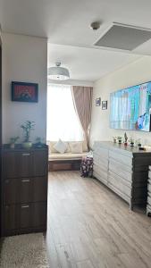 a living room with a couch and a large window at AYARU - APEC MANDALA Codotel SEA VIEW in Tuy Hoa +28 photos