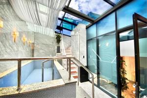 a house with a swimming pool and glass walls at Hotel Voll in Seoul