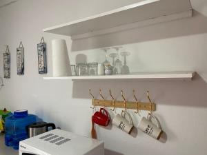 a kitchen with coffee cups hanging on a wall at The Fern Corner Guest House Unit 2 in Letaba