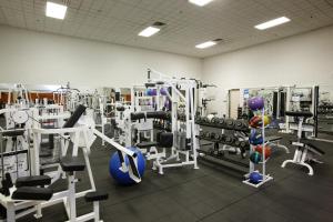 a gym with lots of equipment in a room at The Bertram Inn at Glenmoor in Canton