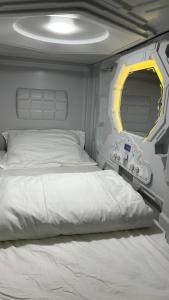 Postel nebo postele na pokoji v ubytování Kiwi Capsule Hotel