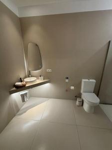 a bathroom with a white toilet and a sink at Osito Hub - Esteban Ballester in Valencia