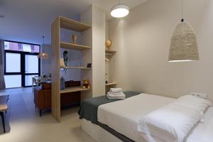a bedroom with a bed and a desk in it at Osito Hub - Esteban Ballester in Valencia +18 photos