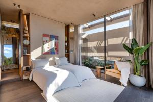 a bedroom with two beds and a large window at Lujo Hotel Bodrum in Guvercinlik +185 photos