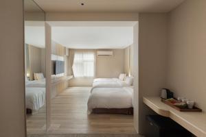 Ένα ή περισσότερα κρεβάτια σε δωμάτιο στο Gamalan Breeze Hotel