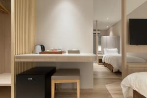 Ένα ή περισσότερα κρεβάτια σε δωμάτιο στο Gamalan Breeze Hotel