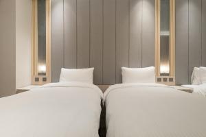 Ένα ή περισσότερα κρεβάτια σε δωμάτιο στο Gamalan Breeze Hotel
