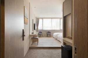 Ένα ή περισσότερα κρεβάτια σε δωμάτιο στο Gamalan Breeze Hotel