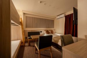 a hotel room with a bed and a desk at RESI STAY Kuon in Kyoto