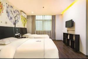 Letto o letti in una camera di Yihai Cultural Hotel Coffee, fruits, snacks, a gym and a laundry room are provided for free in the lobby