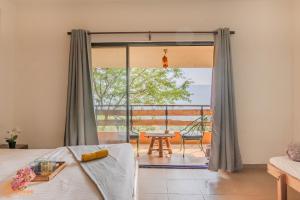 a bedroom with a bed and a large window at Avanti Kalagram Hill Top Resort, Mulshi in Kolvan +117 photos
