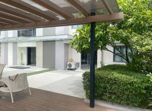 a patio with a chair and a building at Doc Azenith Presidential Suite - Horizon Nica Condos in Cebu City