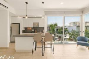 a kitchen with a table and chairs in a room at 1 Br. w5th avenue view Steps from the beach in Playa del Carmen