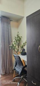 a desk with a chair in a room with a plant at Relaxing Chic Hotel Like with Manila Bay view in Manila