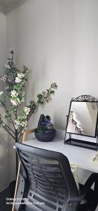a desk with a mirror and a plant on it at Relaxing Chic Hotel Like with Manila Bay view in Manila +6 photos