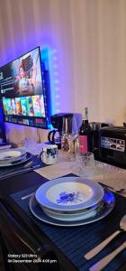 a table topped with plates and a computer monitor at Relaxing Chic Hotel Like with Manila Bay view in Manila