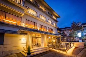 a large building with a patio in front of it at Wafu-no-Yado MASUYA in Yamanouchi