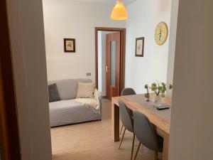 a living room with a table and a couch at Casa pineta in Santa Maria Maggiore +3 photos