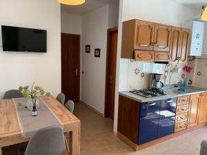 a kitchen with a table and a stove top oven at Casa pineta in Santa Maria Maggiore