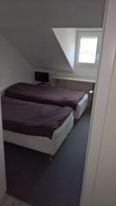 two beds in a small room with a window at Grand T4 Terrasse proche sanctuaire in Lourdes