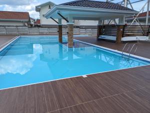 a swimming pool on the roof of a building at Balay Hermosa in Dauis