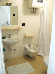 a bathroom with a sink and a toilet at Nino Bixio Apartment in Riva Ligure
