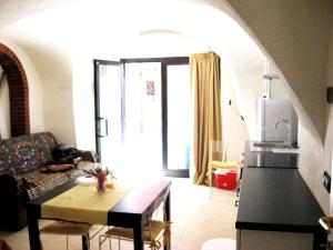a living room with a couch and a table at Nino Bixio Apartment in Riva Ligure