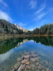 a reflection of a mountain in a lake at Sky Hostel in Peje