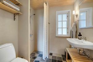 a bathroom with a toilet and a sink at Beautiful House, 1St Row To The Water in Fur +17 photos