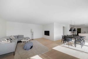a living room with a couch and a table at Holiday Home On Bornholm Close To Sea And Beach in Vester Sømarken