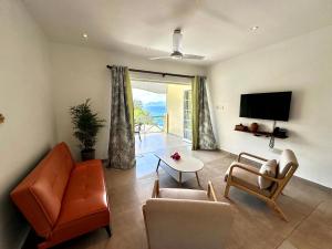 a living room with a couch and a table at Spas Villas La Villa in Victoria