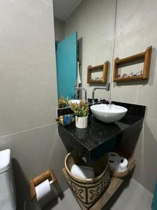 a bathroom with a sink and a mirror and a toilet at Maison Plage Atins - Casa de Praia e Jacuzzi in Atins +6 photos