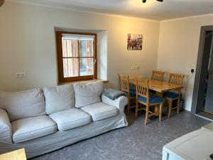 a living room with a couch and a table at Appartementhaus Gastein / Haus Sammie in Bad Gastein
