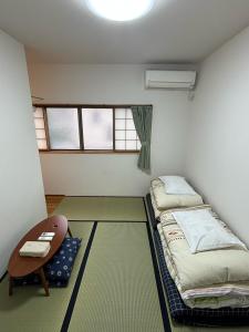 Ένα ή περισσότερα κρεβάτια σε δωμάτιο στο Kanazawa Guesthouse Stella