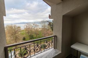 a balcony with a view of the water at Artist House in Pogradec