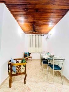 a dining room with a table and chairs at Ranga's House in Weligama +13 photos