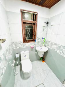 a bathroom with a toilet and a sink at Ranga's House in Weligama