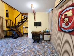 a room with a staircase and a room with a desk at Baibon 4 Homestay Thalang Phuke in Thalang