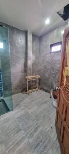 a bathroom with a shower and a glass door at Baibon 4 Homestay Thalang Phuke in Thalang