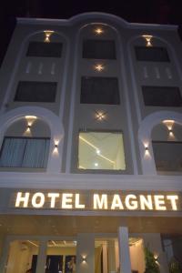 a hotelmanagement sign on the front of a building at Hotel Magnet in Indore