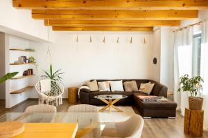 a living room with a couch and a table at Cool Mountain Escape - AC - Summer Cinema - 2BR Family Apartment - Garden - Liptov in Liptovská Kokava