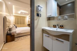 un bagno con un lavandino e un letto in una stanza di Luxury Chaouen a Chefchaouen