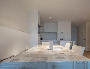 a dining room with a table and a kitchen at Duinhof VI 6 in Cadzand +1 photo