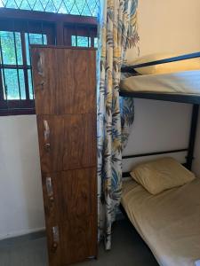 a bunk bed with a dresser next to a bunk bed at Dihein surf Hostel in Ahangama +17 photos