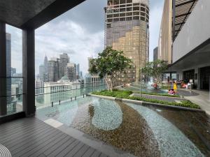 a pool on the roof of a building with a city at AXON RESIDENCE BUKIT BINTANG KL CITY View in Kuala Lumpur