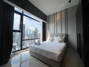 a bedroom with a large bed and a large window at AXON RESIDENCE BUKIT BINTANG KL CITY View in Kuala Lumpur +66 photos