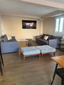 a living room with two couches and a table at Alegoría Coliving Experience in Seville