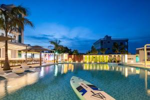 a pool with a paddle board in the water at night at Sanya Haishi Swimming Pool Design Hotel in Sanya +101 photos