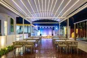 a row of tables and chairs in a restaurant at Sanya Haishi Swimming Pool Design Hotel in Sanya